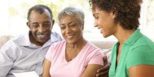 a younger woman talking to an older woman and an older man
