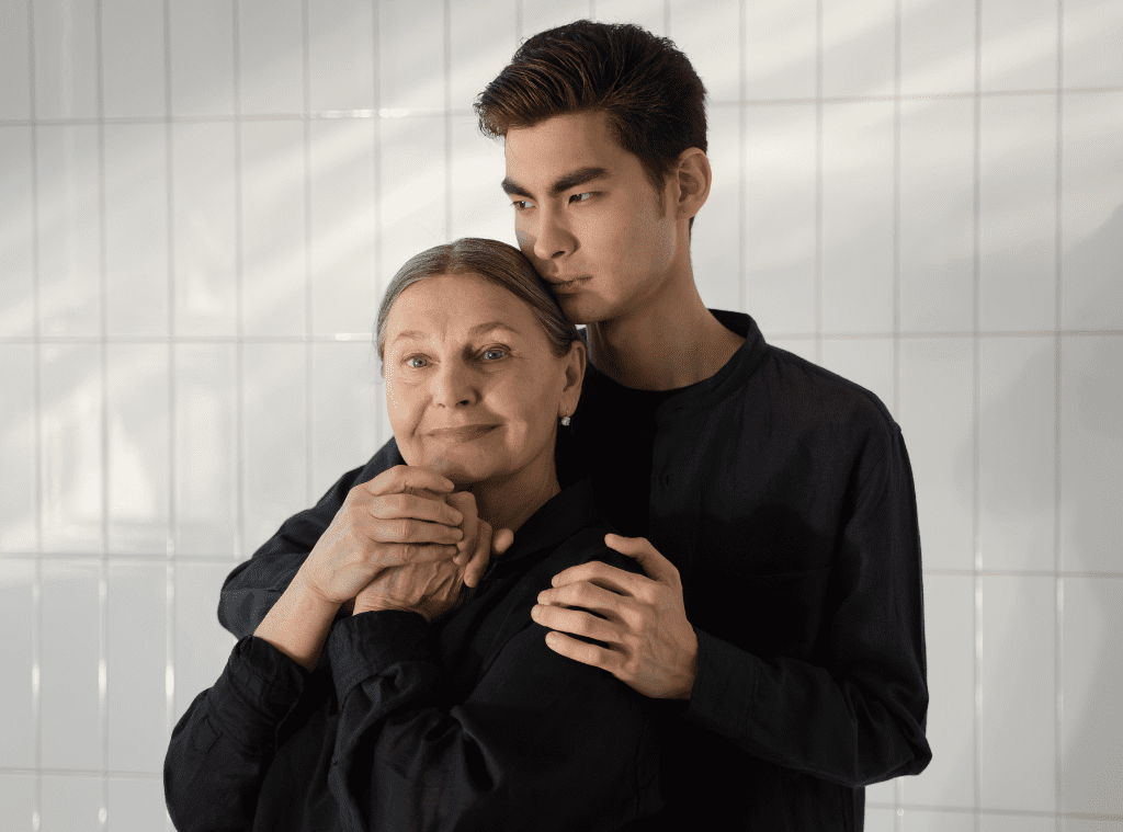 parkinson's in-home care for mother with her son hugging her