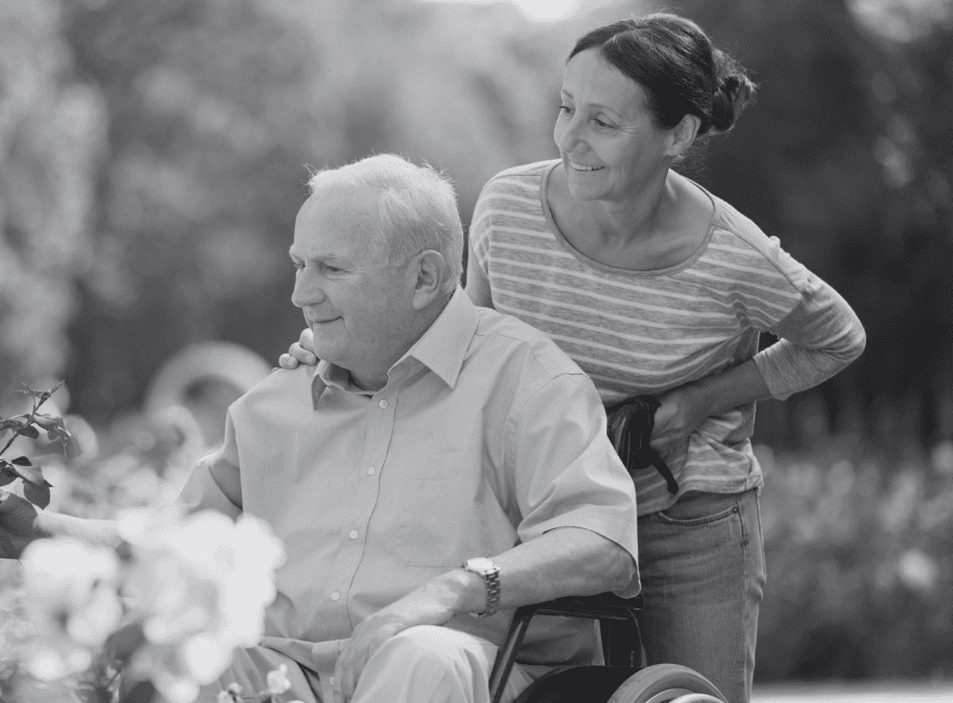 A caregiver spending time outside with an elderly client